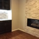 fireplace remodel, stone surround, dark cabinets, shaker cabinets, glass front cabinets, stone back splash, dry stack stone, add wet bar, granite countertop