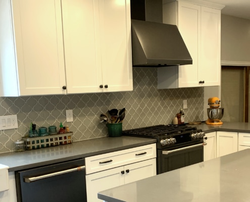 kitchen remodel, white cabinets, dark hardware, black stainless steel appliances, quartz counter tops, glass tile backsplash
