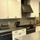 kitchen remodel, white cabinets, dark hardware, black stainless steel appliances, quartz counter tops, glass tile backsplash