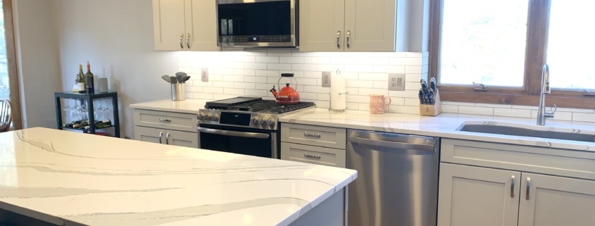 White cabinets, Stainless Steel Appliances, Breakfast Bar, Subway Tile Backsplash, Quartz Counter